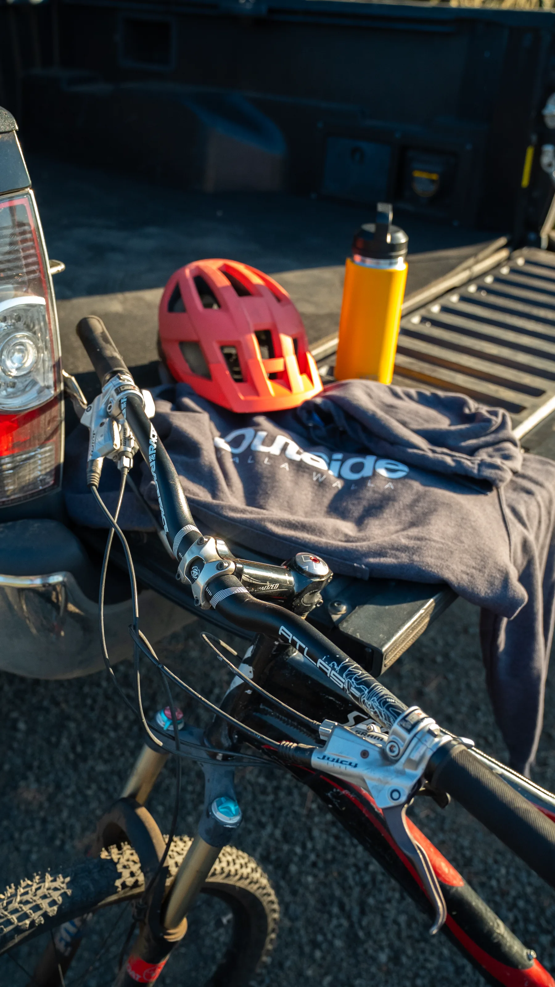 Outside Walla Walla hoodie on a truck tailgate with a mountain bike